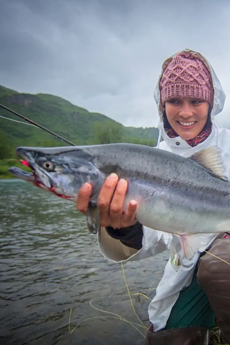 happy woman holding fish