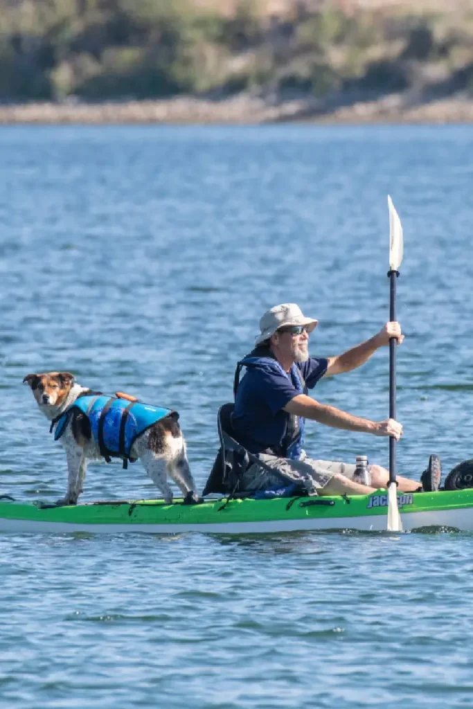 man with his dog kayaking