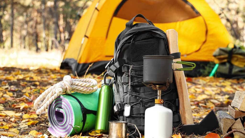 Camping gear with yellow tent behind